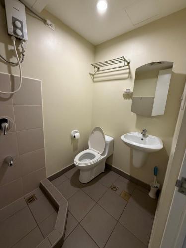 a bathroom with a toilet and a sink at Cebu AvidaRiala Condotel by Go2Stays in Cebu City
