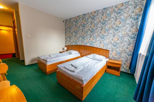 Postel nebo postele na pokoji v ubytování Bobrowy Resort