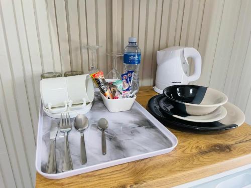 a tray with utensils on top of a table at Quiet Corner Guest House Kokstad in Kokstad