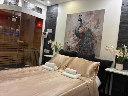 a bedroom with a bed with a painting on the wall at Bed & Wellness Angie in Almere