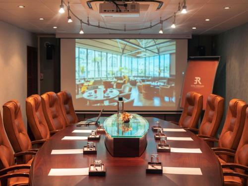 a conference room with a large table and chairs at Royal Emeraude Hotel Dinard - MGallery Collection in Dinard