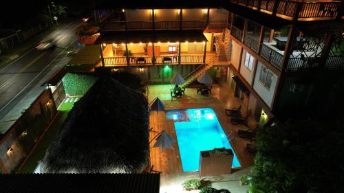 an overhead view of a building with a swimming pool at KETHALYA TAYRONA Hostal in El Zaino