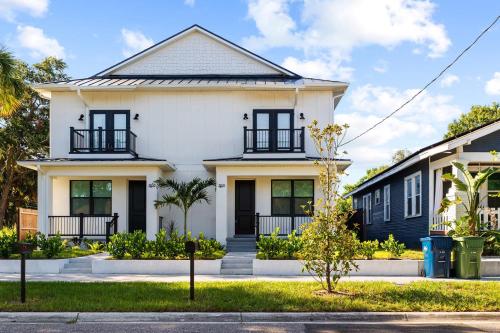 a white house with black shutters at New build in Old West #2 3 Bed 2 Bath Family Rental in Tampa