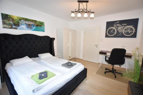 a bedroom with a bed and a desk and a bike on the wall at Ein Traum im Leechwald nähe LKH in Graz