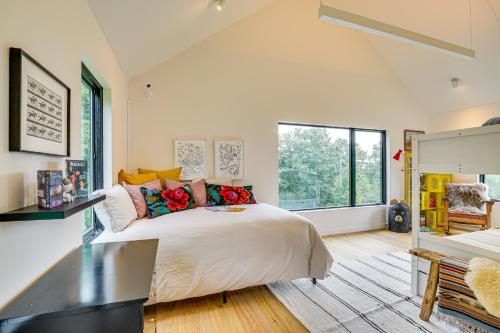 a bedroom with a large bed and a large window at Pool and Private Acreage Luxe Hudson Valley Home in Pine Plains