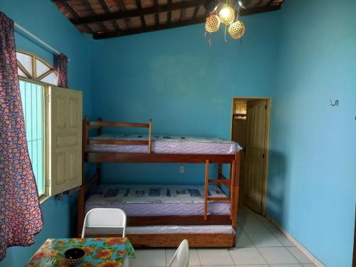 a room with two bunk beds and a table at Hostel Ariramba in Belém