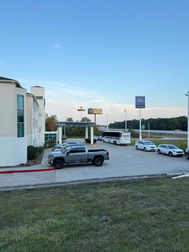 a car parked in a parking lot next to a gas station at Baymont by Wyndham Kingdom City in Kingdom City