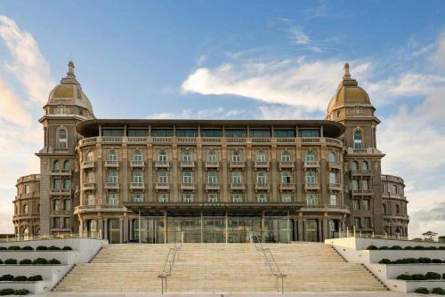 a large building with stairs in front of it at Sofitel Montevideo Casino Carrasco & Spa in Montevideo