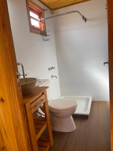 a bathroom with a toilet and a sink and a tub at Complejo Juan Pablo in Colón