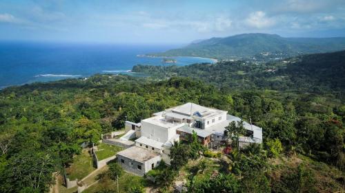 an aerial view of a house on a hill at Breezy Castle Villa with private pool overlooking the Sea and Blue Mountains in Port Maria