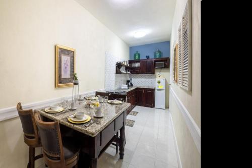 a kitchen with a table and chairs and a kitchen with a kitchen at Breezy Castle Villa with private pool overlooking the Sea and Blue Mountains in Port Maria