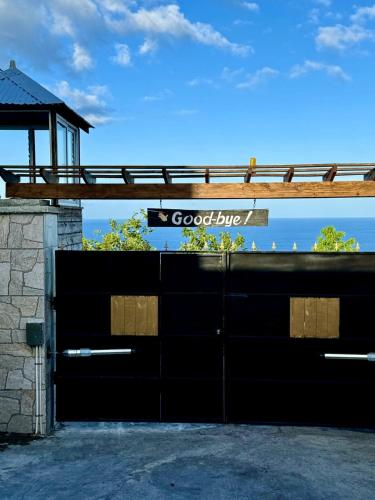 a black garage door with a good bite sign on it at Breezy Castle Villa with private pool overlooking the Sea and Blue Mountains in Port Maria
