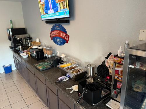 a kitchen with a counter top with a counter top at Baymont by Wyndham Kingdom City in Kingdom City