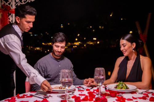 a group of people sitting at a table with a plate of food at Barceló Karmina - All Inclusive in Manzanillo