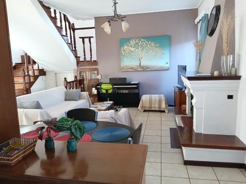 a living room with a couch and a table at Melody cottage, Samos in Karlovasi