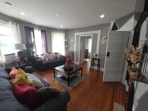 a living room with a couch and a table at downtown and secluded in Manchester