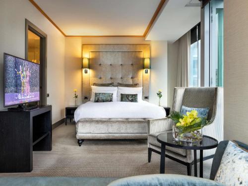 a hotel room with a bed and a television at Sofitel Auckland Viaduct Harbour in Auckland