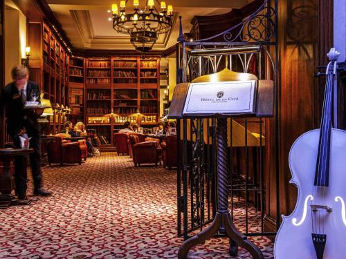 a room with a violin and a guitar on display at Hotel de la Cité Carcassonne - MGallery Collection in Carcassonne