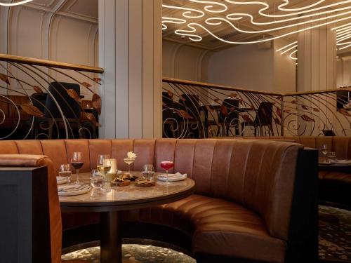 a table in a restaurant with glasses of wine at The Playford Adelaide - MGallery in Adelaide