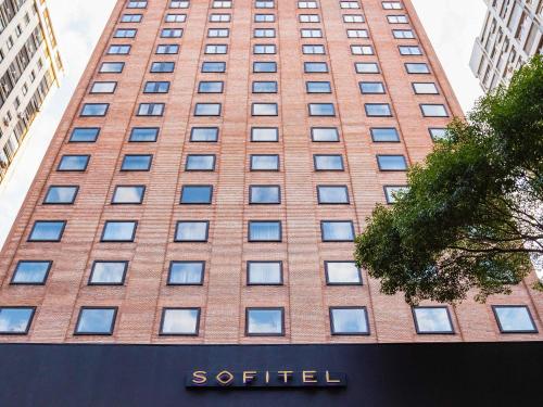a tall brick building with a sign in front of it at Sofitel Buenos Aires Recoleta in Buenos Aires