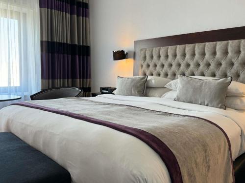 a large bed in a hotel room with a large bedspread at Sofitel Buenos Aires Recoleta in Buenos Aires