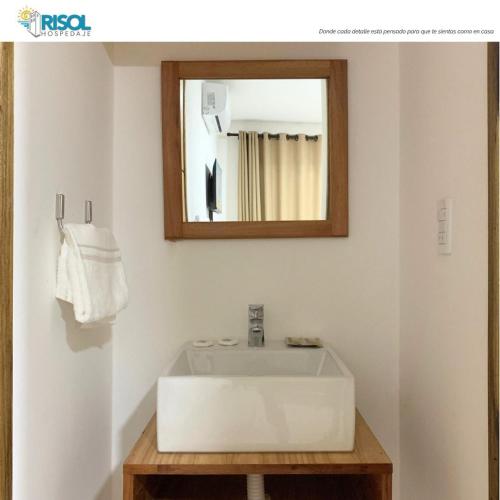 a bathroom with a white sink and a mirror at Risol in Encarnación
