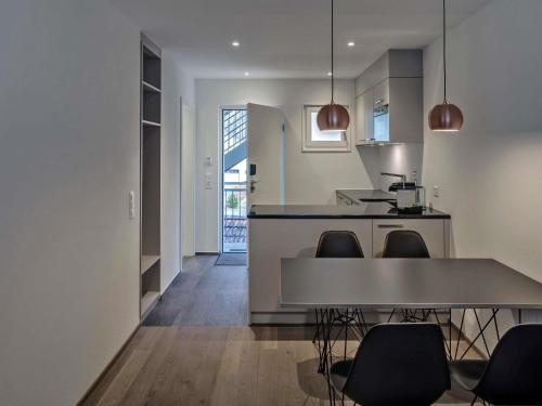 a kitchen and dining room with a table and chairs at Royal St. Georges Hotel Interlaken - MGallery Collection in Interlaken