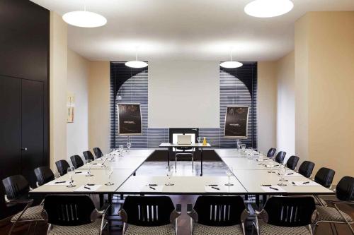 a large conference room with a large table and chairs at Royal St. Georges Hotel Interlaken - MGallery Collection in Interlaken