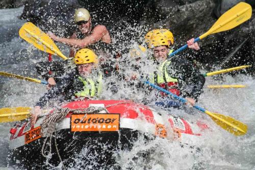 a group of people in a raft in the water at Royal St. Georges Hotel Interlaken - MGallery Collection in Interlaken
