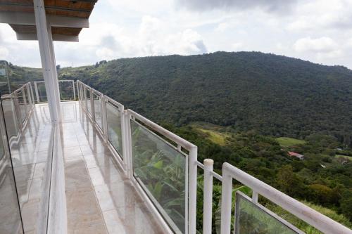 a balcony with a view of a mountain at Bills Ventarron in Cali