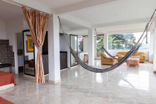 a hammock in the living room of a house at Bills Ventarron in Cali