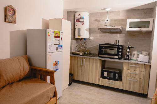 a small kitchen with a refrigerator and a microwave at Asturiano 6 Miramar in Miramar