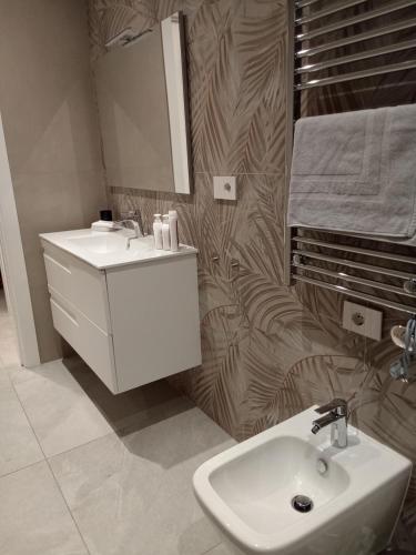 a bathroom with a white sink and a mirror at Residenza Milla in Alassio