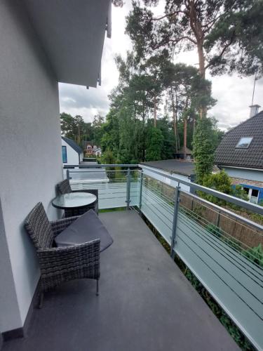 a patio with two chairs and a table on a balcony at Villa6 in Pobierowo