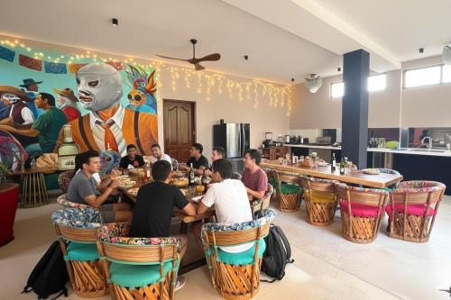 a group of people sitting at a table in a restaurant at Casa Mexico Lindo - Boutique Hostel in Bacalar