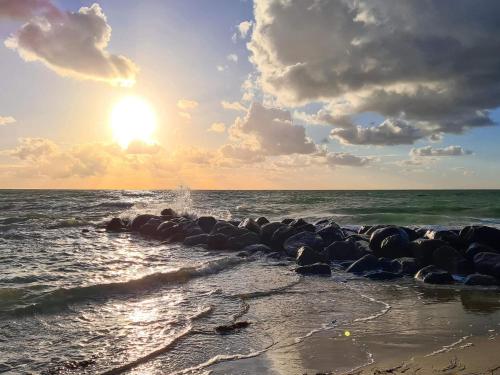a group of rocks on the shore of the ocean at 12 person holiday home in Hundested-By Traum in Hundested