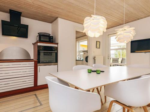 a kitchen and dining room with a white table and chairs at 8 person holiday home in Skagen-By Traum in Skagen