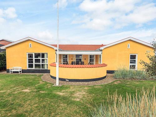 a yellow house with a red roof at 8 person holiday home in Skagen-By Traum in Skagen