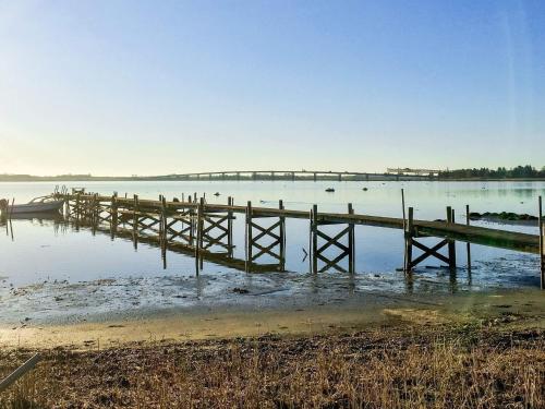 a dock on a lake with a bridge in the background at 5 person holiday home in Jægerspris-By Traum in Jægerspris