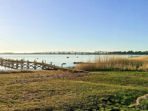 a bridge over a body of water with grass at 5 person holiday home in Jægerspris-By Traum in Jægerspris