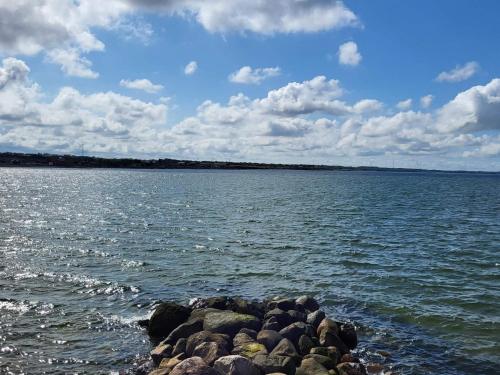 a large body of water with rocks in the water at 8 person holiday home in Vinderup-By Traum in Vinderup