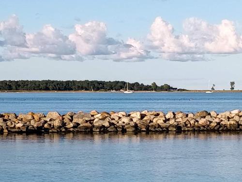 a group of rocks in the water near a body of water at Charming Retreat by Water - By Traum Ferienwohnungen in Nykøbing Sjælland