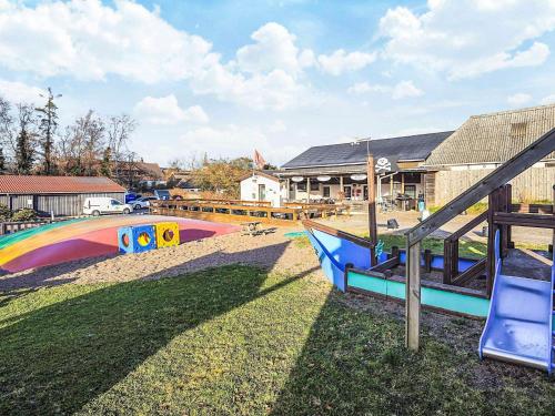 a playground with a slide and a rainbow at 3 person holiday park home in Gørlev in Gørlev