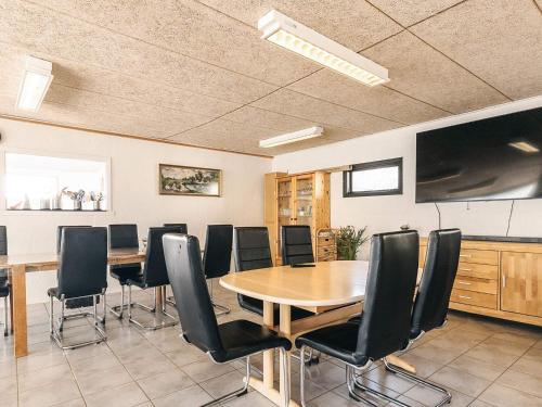 a conference room with a table and black chairs at 3 person holiday park home in Gørlev in Gørlev