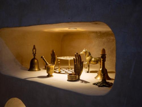 a shelf with a figurine of a horse and a table at Riad Qasr El Medina in Tangier