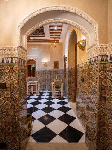 an ornate room with a black and white checkered floor at Riad Qasr El Medina in Tangier