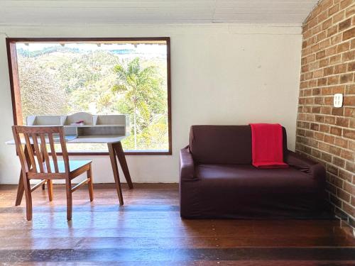 a living room with a couch and a table at Luxury Retreat, Vale do Cafe, RJ in Paty do Alferes