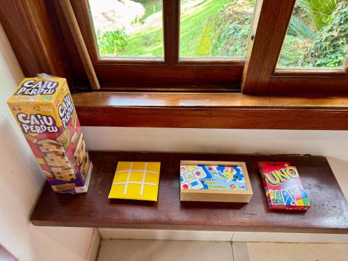 a shelf with two boxes of cereal and a window at Luxury Retreat, Vale do Cafe, RJ in Paty do Alferes