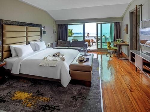 a large bedroom with a large bed and a living room at The Artisan Hotel Istanbul - MGallery Collection in Istanbul