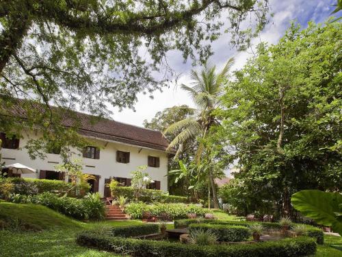 an exterior view of a house with a garden at 3 Nagas Hotel Luang Prabang - MGallery Collection in Luang Prabang